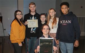 6th place student team holding certificate and movie poster 